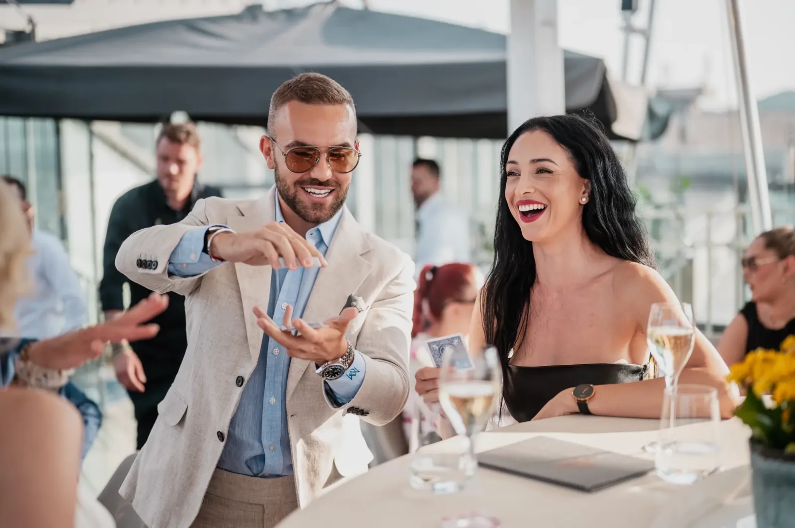 Matteo performing close-up magic at rooftop event