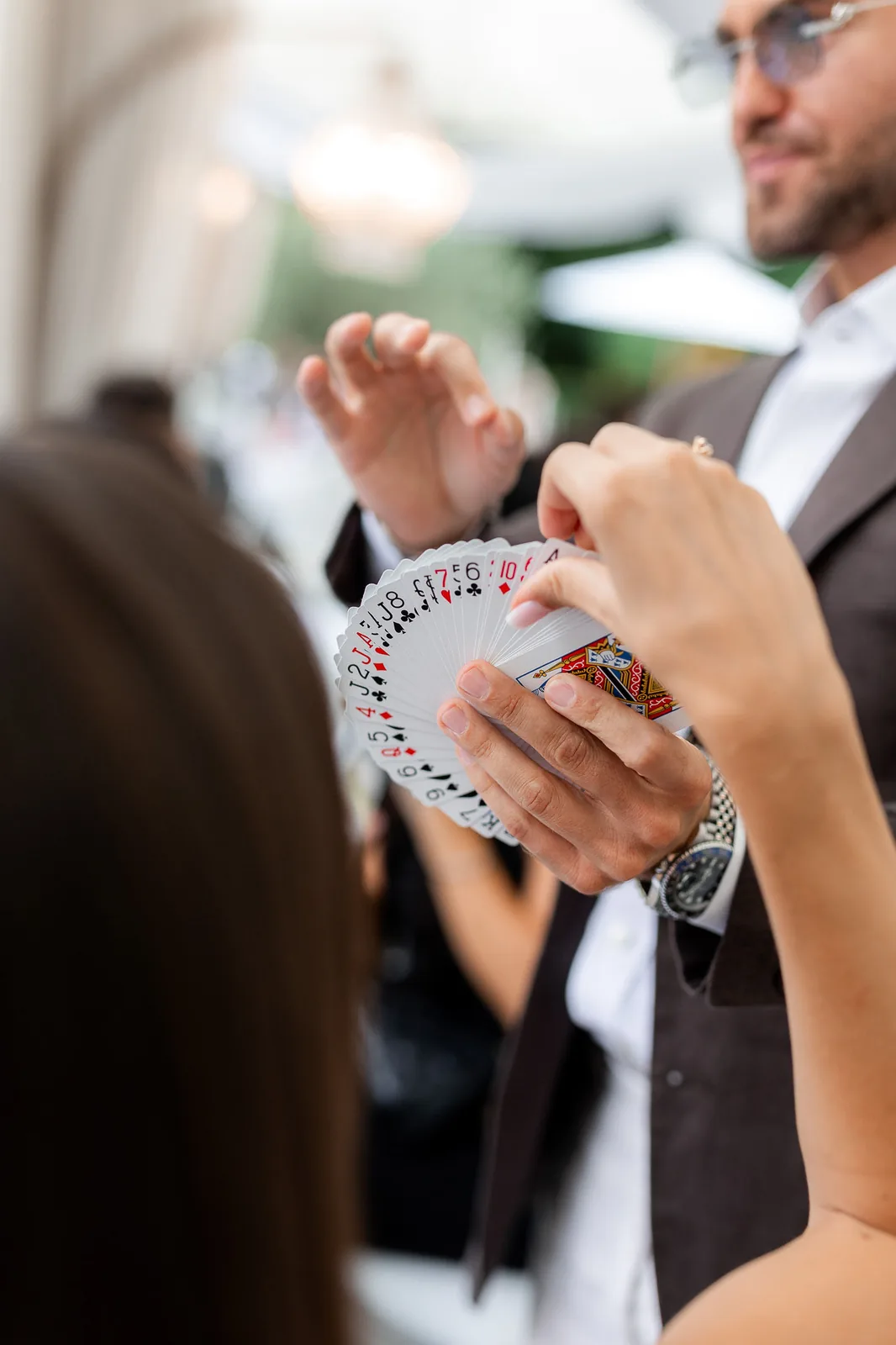 Guest selecting a card from fanned deck