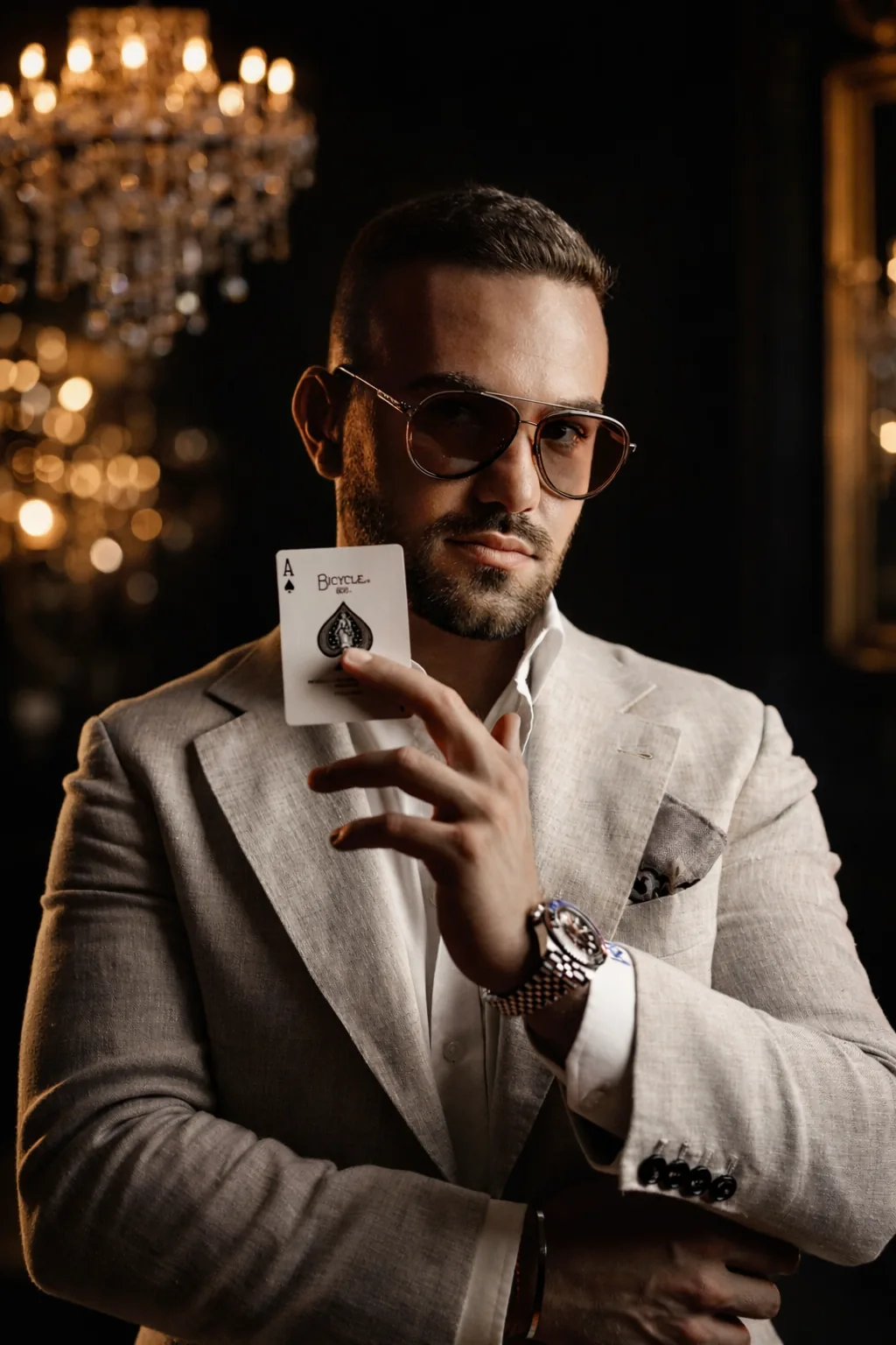 Matteo Cammisa — International luxury magician and mentalist holding an ace of spades in an elegant setting