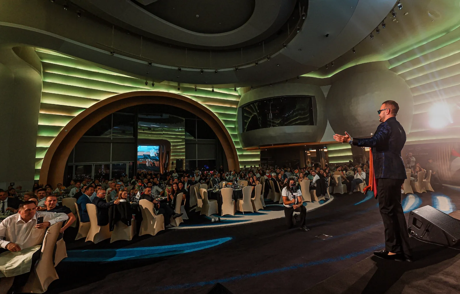 Matteo Cammisa performing a stage show to a seated gala audience of several hundred guests at the V Hotel Dubai