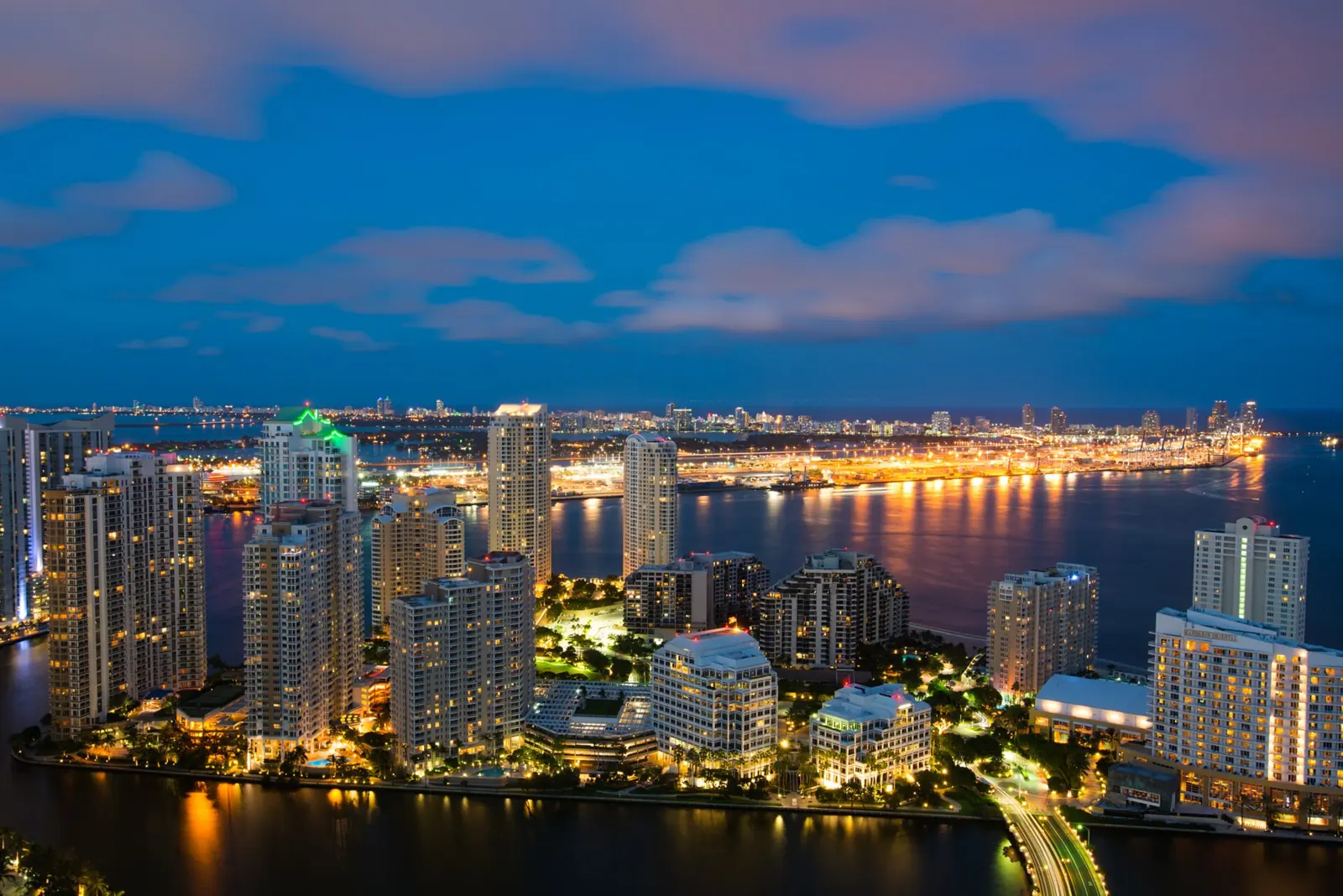 The Miami skyline glowing at dusk over Biscayne Bay
