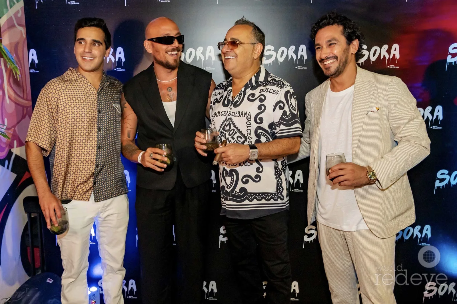 Elliot and Benny Aboud with guests on the Sora step-and-repeat at the Wynwood opening
