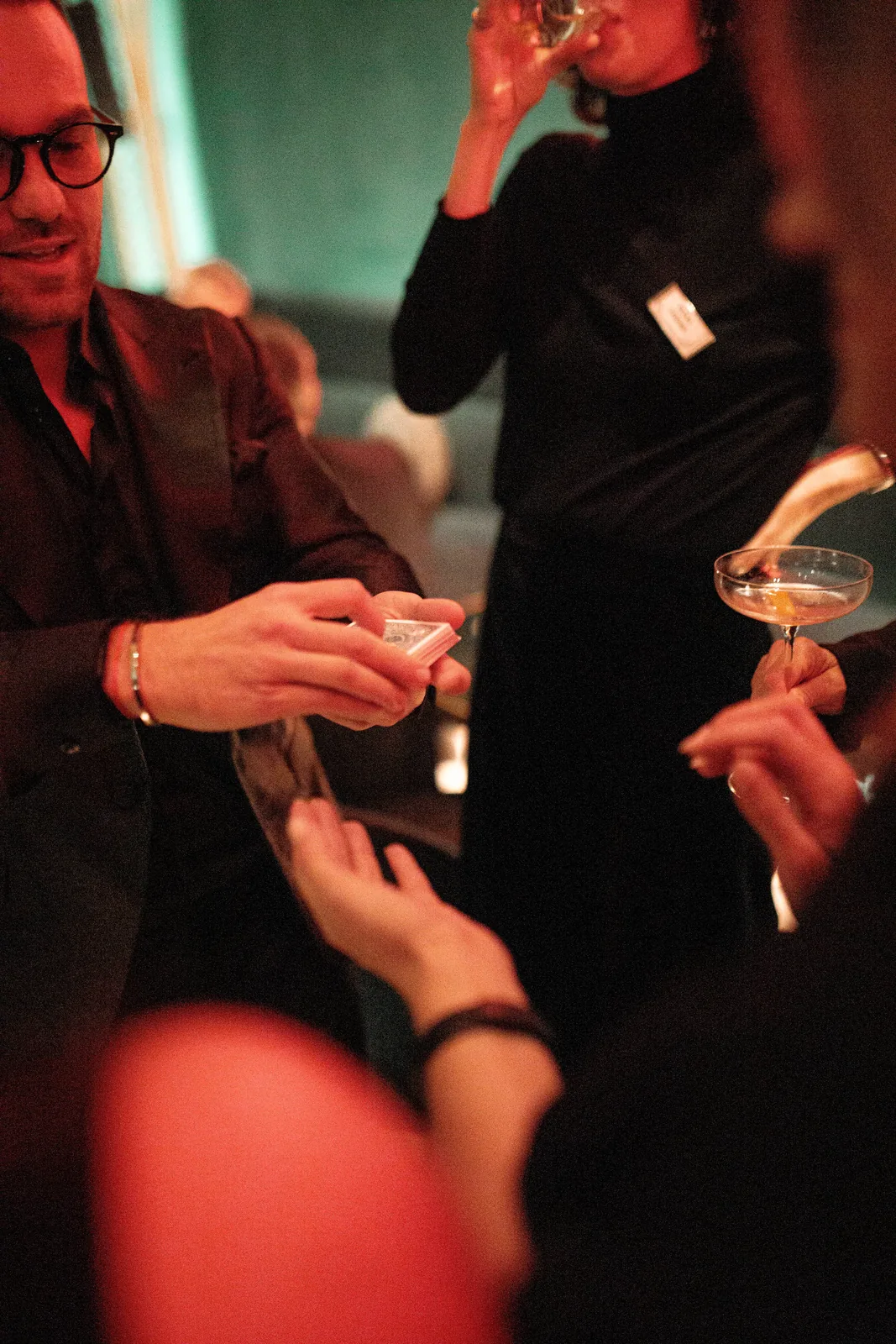 Guests reacting to close-up card magic at W Budapest